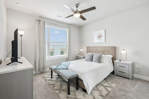 Bedroom with ceiling fan at The Sevens in Dallas TX