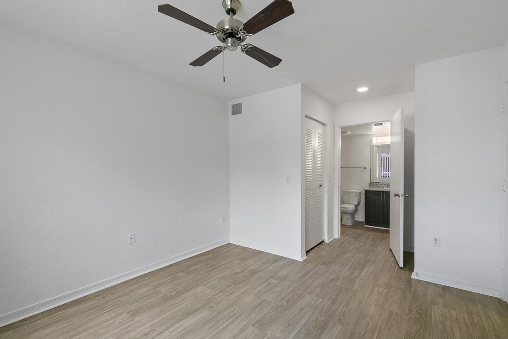 Bedroom with attached bathroom at Brenton at Abbey Park Apartments in West Palm Beach FL