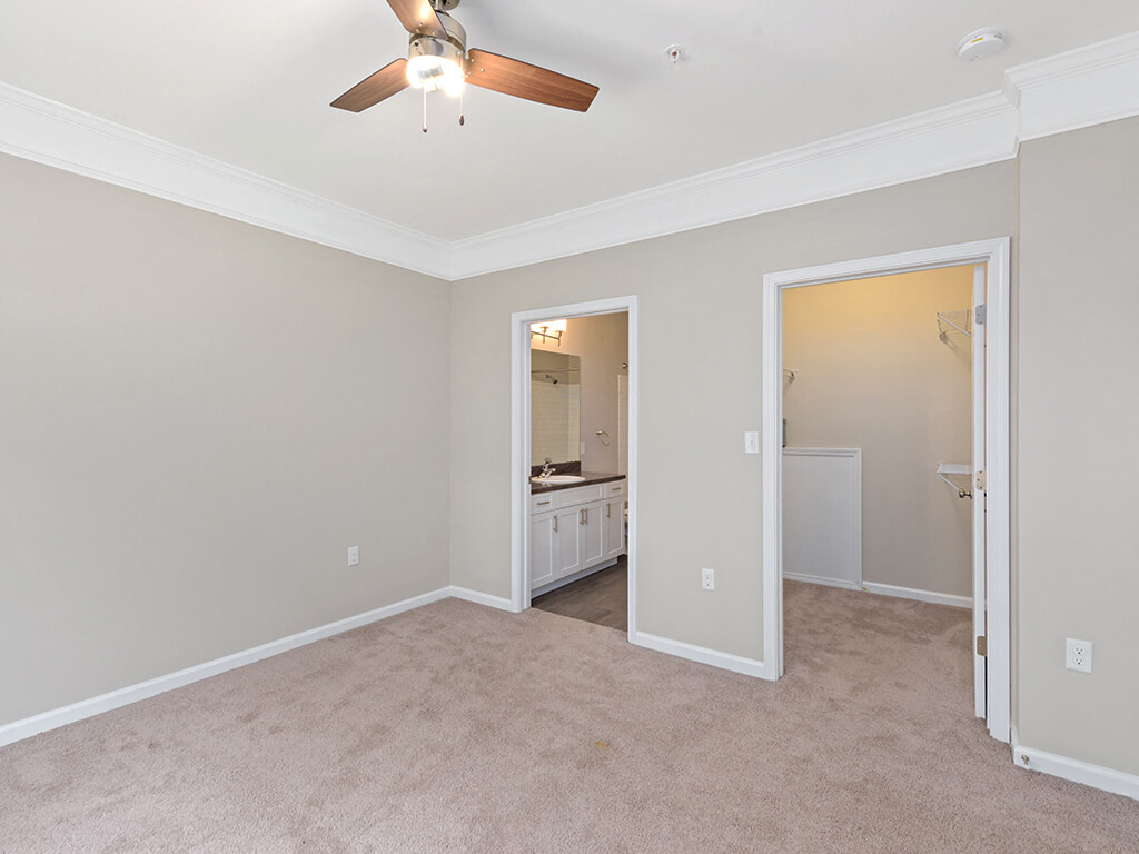 Bedroom with attached bathroom and closet at Falls Pointe Apartments in Durham NC
