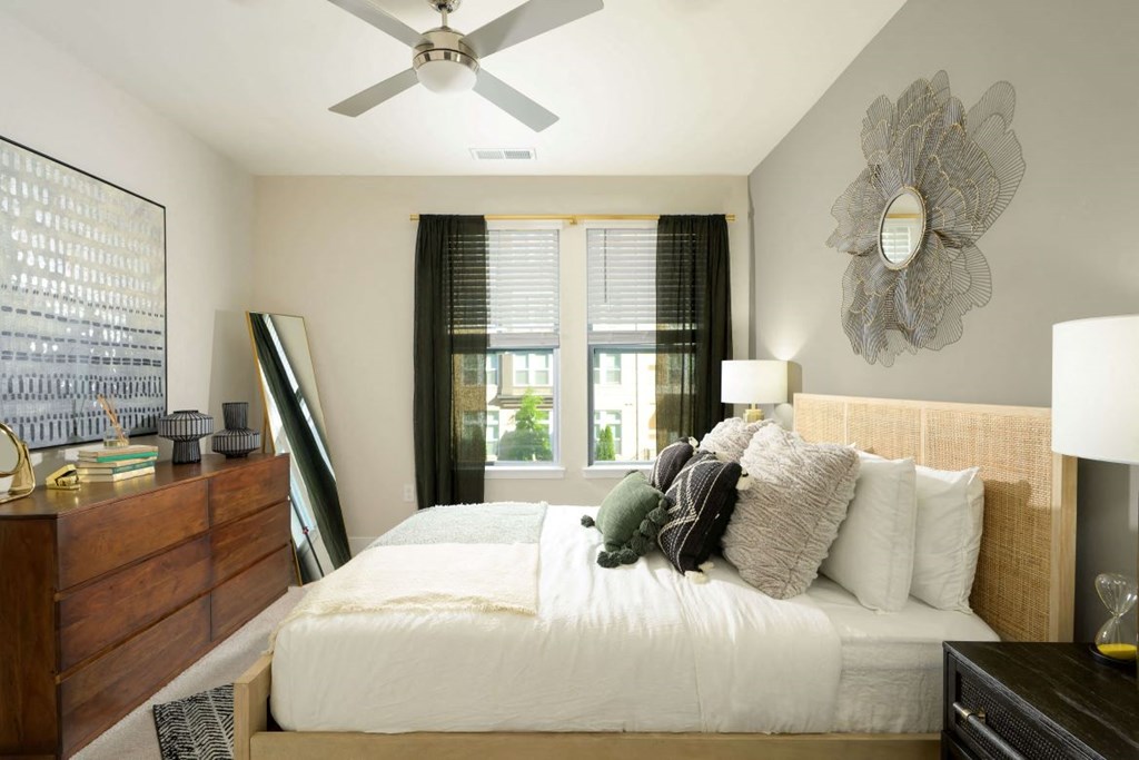 Bedroom with ceiling fan and window at the Moxley in Fairfax VA