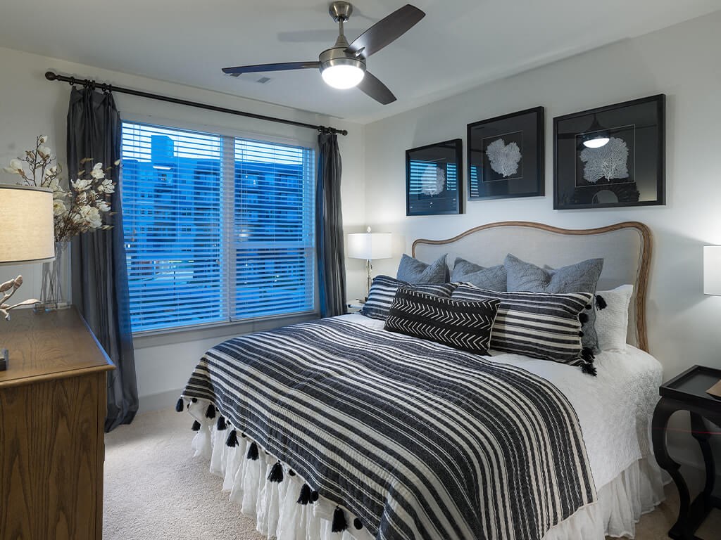 Bedroom with ceiling fan and window at Cirro King of Prussia Apartments in King of Prussia PA