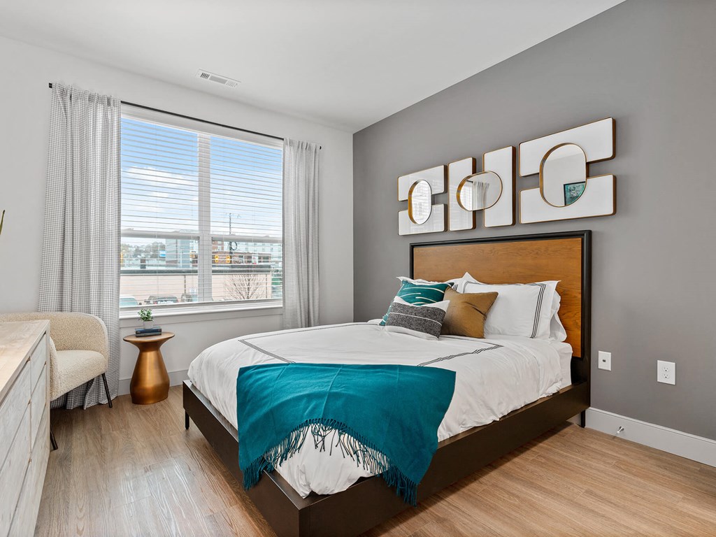 Bedroom with hardwood flooring at VERO Apartments in Chelsea MA