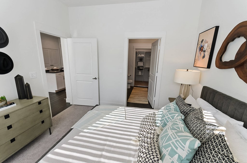 Bedroom with attached bathroom and closet at Opal Legacy Central in Plano TX