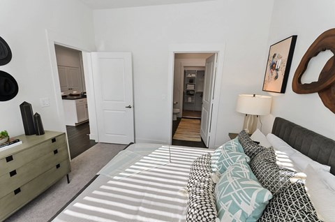 Bedroom with attached bathroom and closet at Opal Legacy Central in Plano TX