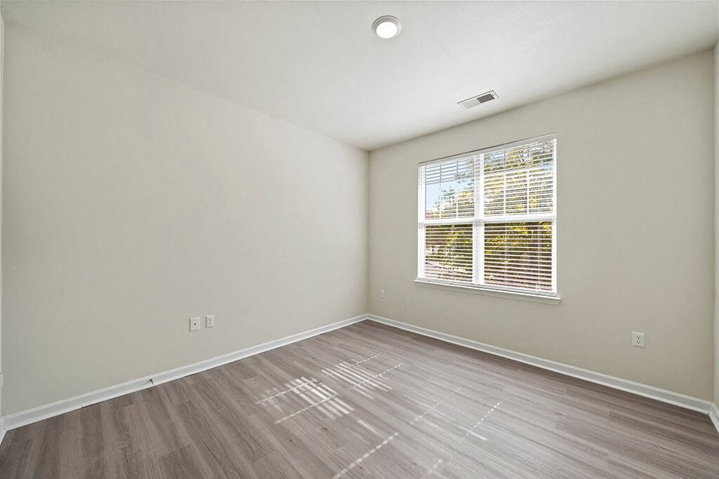 Living room with wood style flooring at Grand Oaks in Chester VA