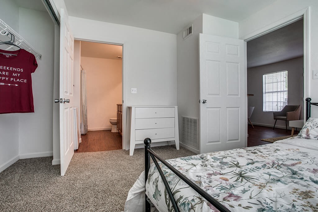 Bedroom with bed and closet at Forest Creek Apartments in Houston TX
