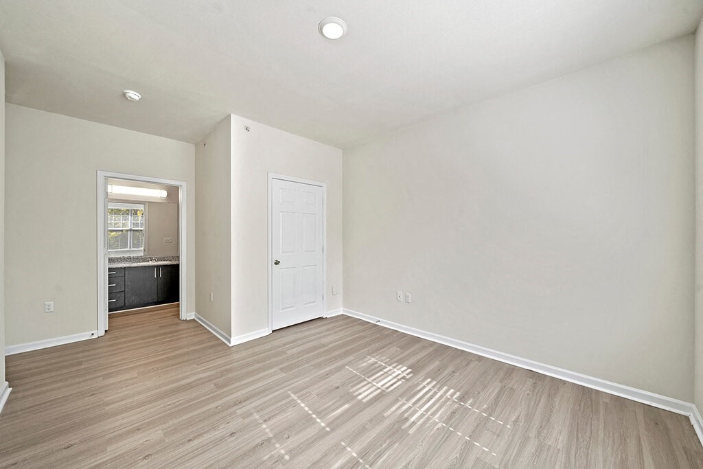 Living room with wood style plank flooring at Grand Oaks in Chester VA