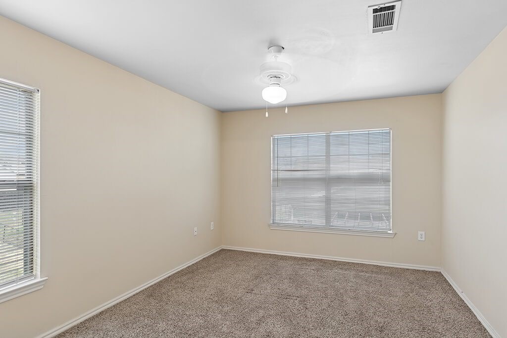 Bedroom with window at Ironwood Crossing Apartments and Townhomes in Fort Worth TX