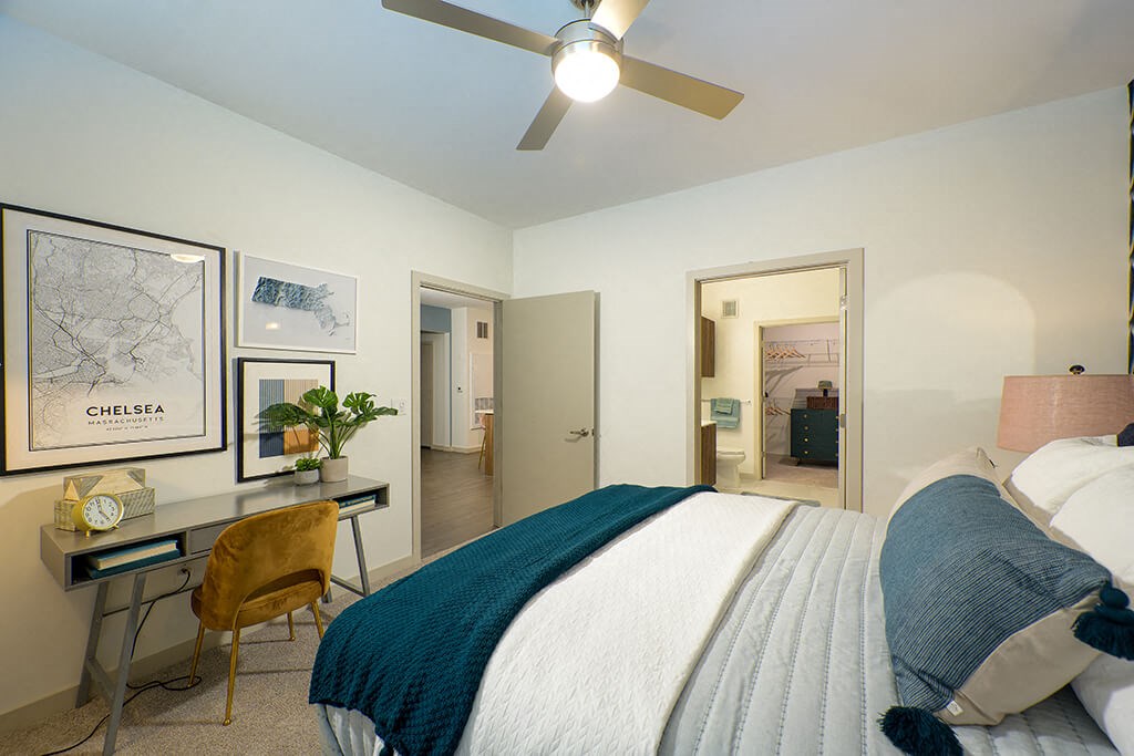 a bedroom with a bed and a ceiling fan