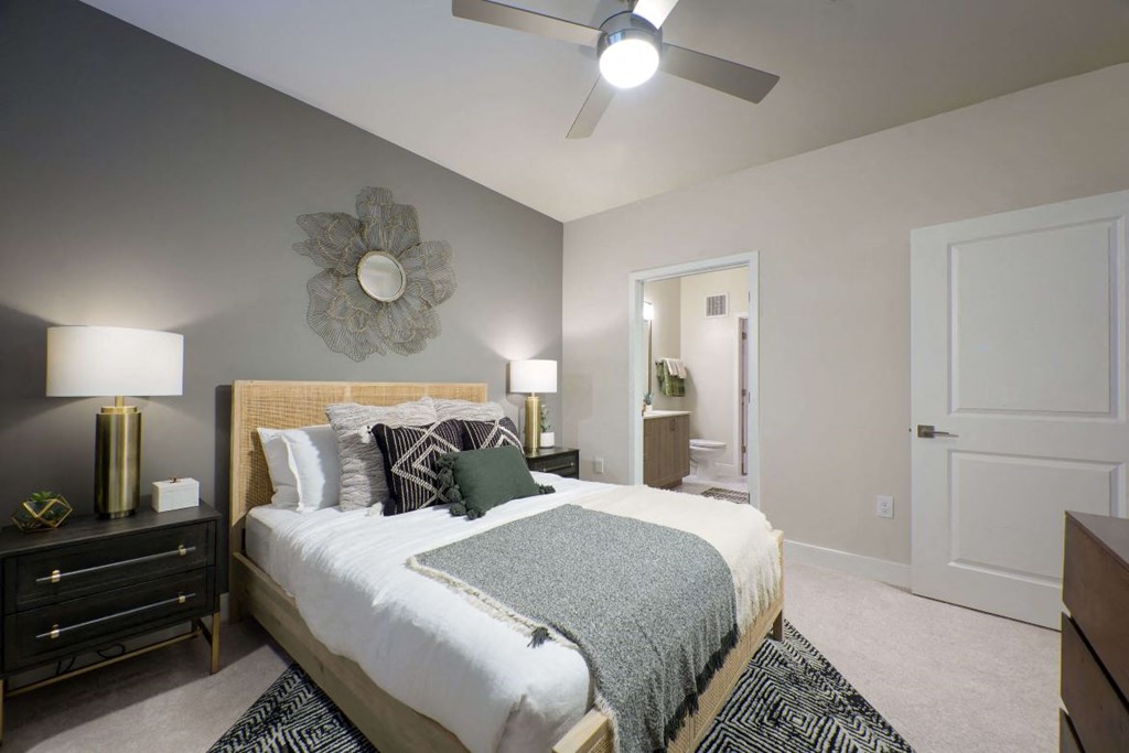 Bedroom with large bed and ceiling fan at the Moxley in Fairfax VA