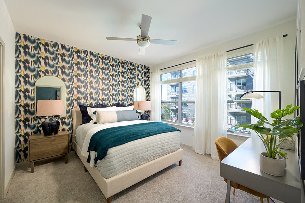 a bedroom with a bed and a ceiling fan