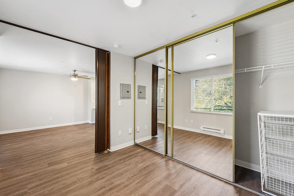 Bedroom with mirror closet at Auburn Court Apartments in Auburn WA