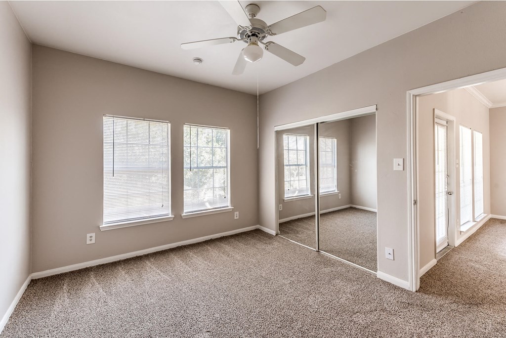 Bedroom with ceiling fan at Hollow Creek in Conroe TX
