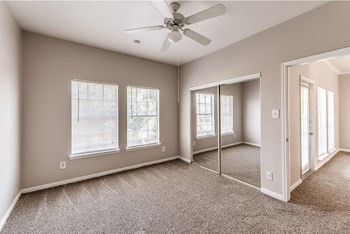 Bedroom with ceiling fan at Hollow Creek in Conroe TX - Photo Gallery 5