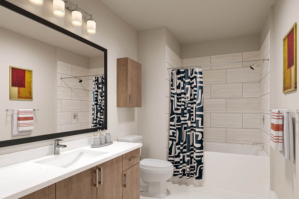 a bathroom with a white toilet and a black and white shower curtain