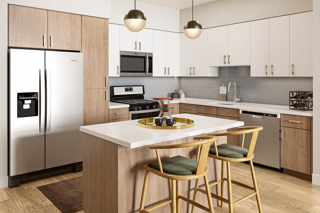 a kitchen with white cabinets and a large island with two stools