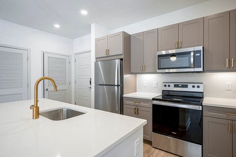 Brass Design Package Kitchen Island at The Belhaven Apartments  in Alexandria, VA