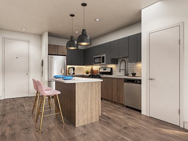 Kitchen in brass color scheme with island seating at V2 Apartments in Chelsea MA