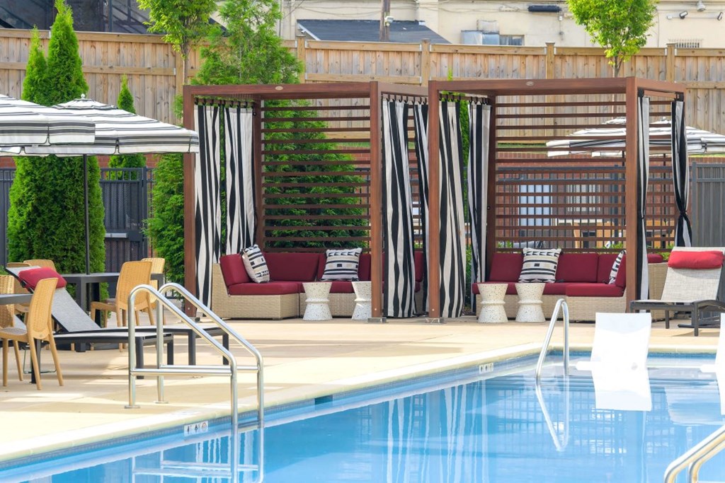 a swimming pool with chairs and umbrellas at a hotel pool