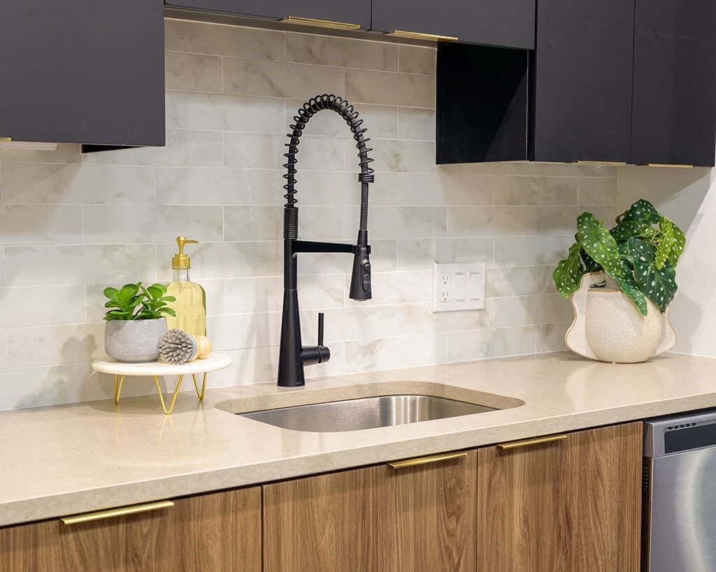 a kitchen with a sink and a black faucet