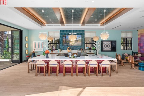 A dining room with a long table and chairs.