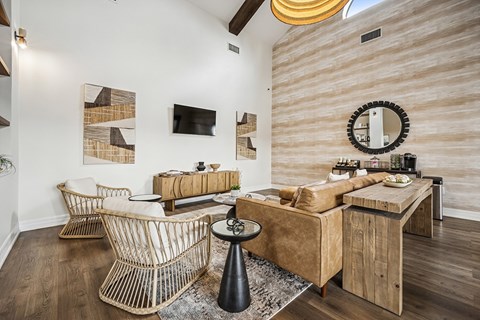 A living room with a brown couch and a woven chair.