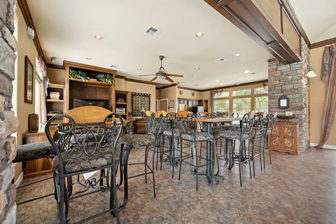 a dining room with tables and chairs and a fireplace