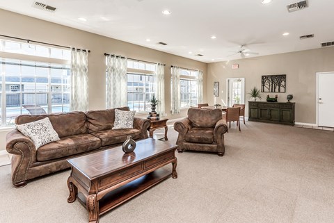 a living room with couches and chairs and a table