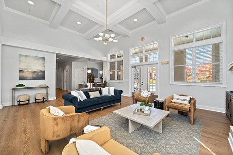 A living room with a blue couch and a brown armchair.