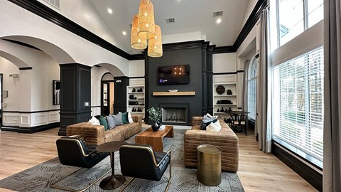 a living room with couches and chairs and a television