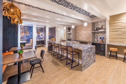 a kitchen and dining area with a marble counter top and a long table with chairs