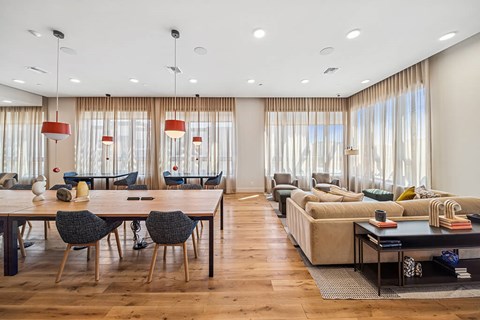 A modern living room with a dining table and chairs.