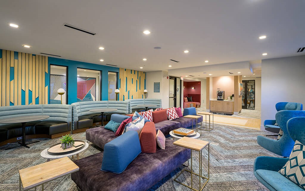 a large living room with couches and chairs