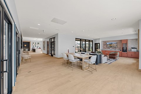 A spacious room with a dining table and chairs.