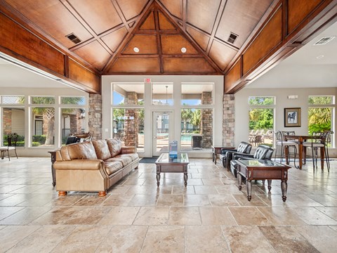 A living room with a tan couch and a coffee table.