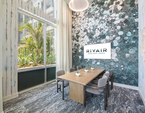A conference room with a table and chairs and a sign that says "Rivair".