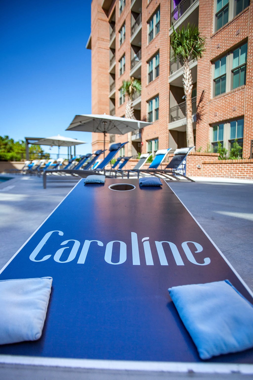 Outdoor corn hole game at Caroline Apartments in Charleston SC