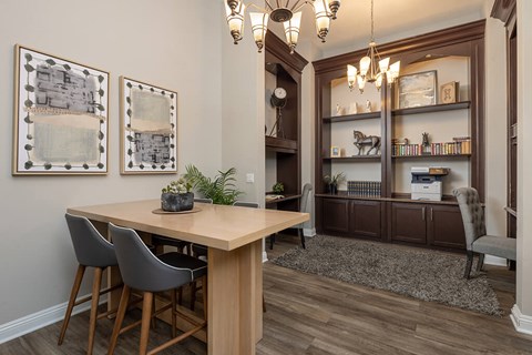 A dining room with a wooden table and chairs.