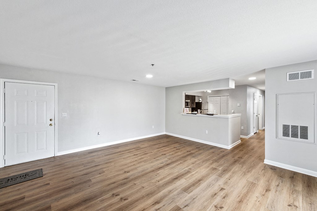 Open concept apartment with hardwood style flooring at England Run Apartments in Fredericksburg VA