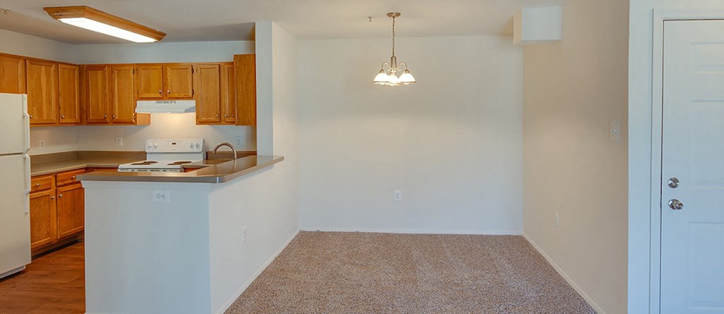 Dining room with view of kitchen at Riverwoods, Riverwoods at Towne Square, and Riverwoods at Lake Ridge in Woodbridge VA