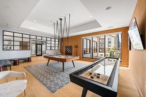 A room with a pool table and a couch.