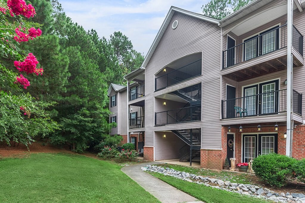 Lawn and apartment exteriors at Greens of Pine Glen in Durham NC