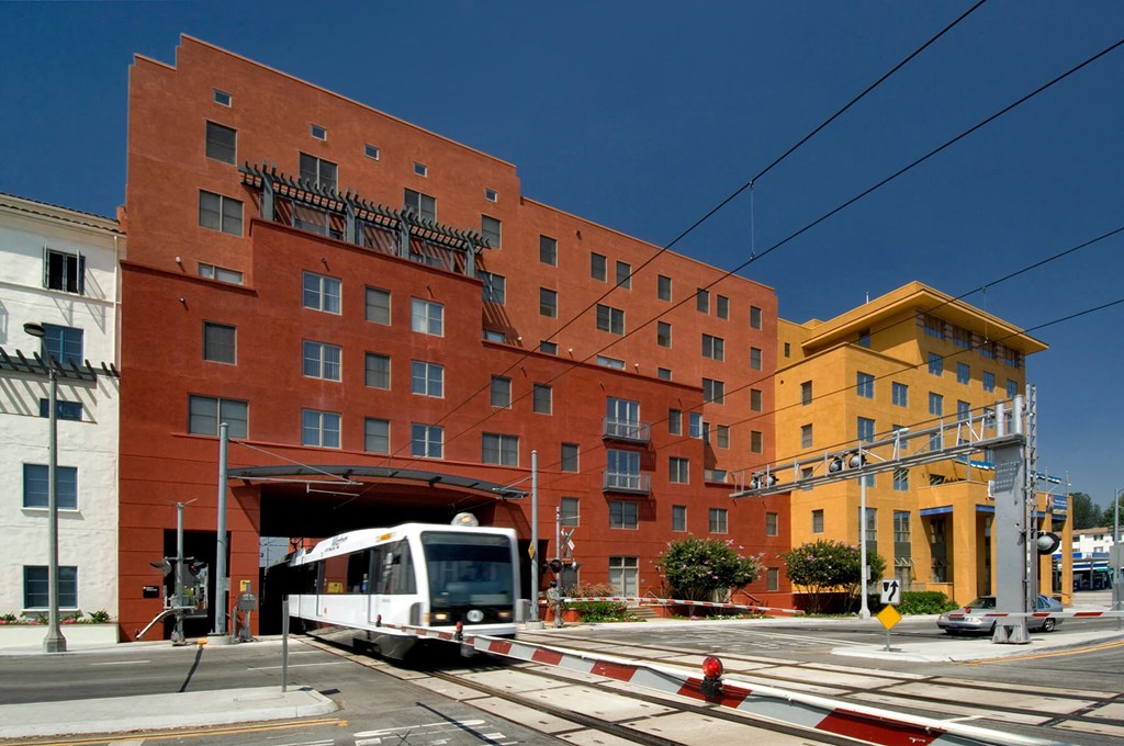 Exterior Building and Gold Line Train at Haven at Del Mar Station Apartments in Pasadena CA