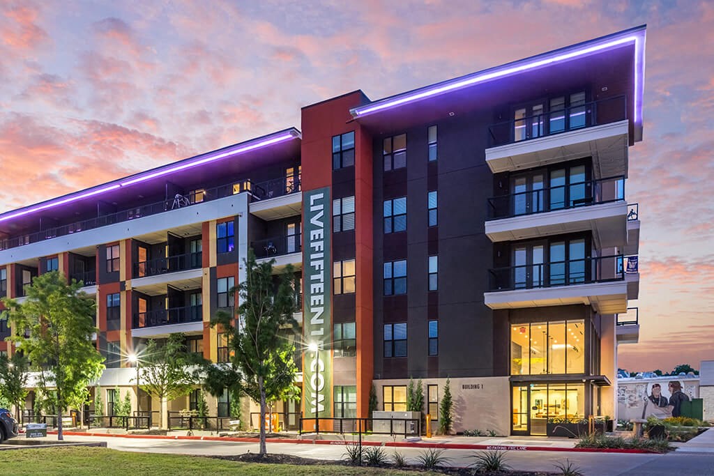 a rendering of a building with purple lights at dusk