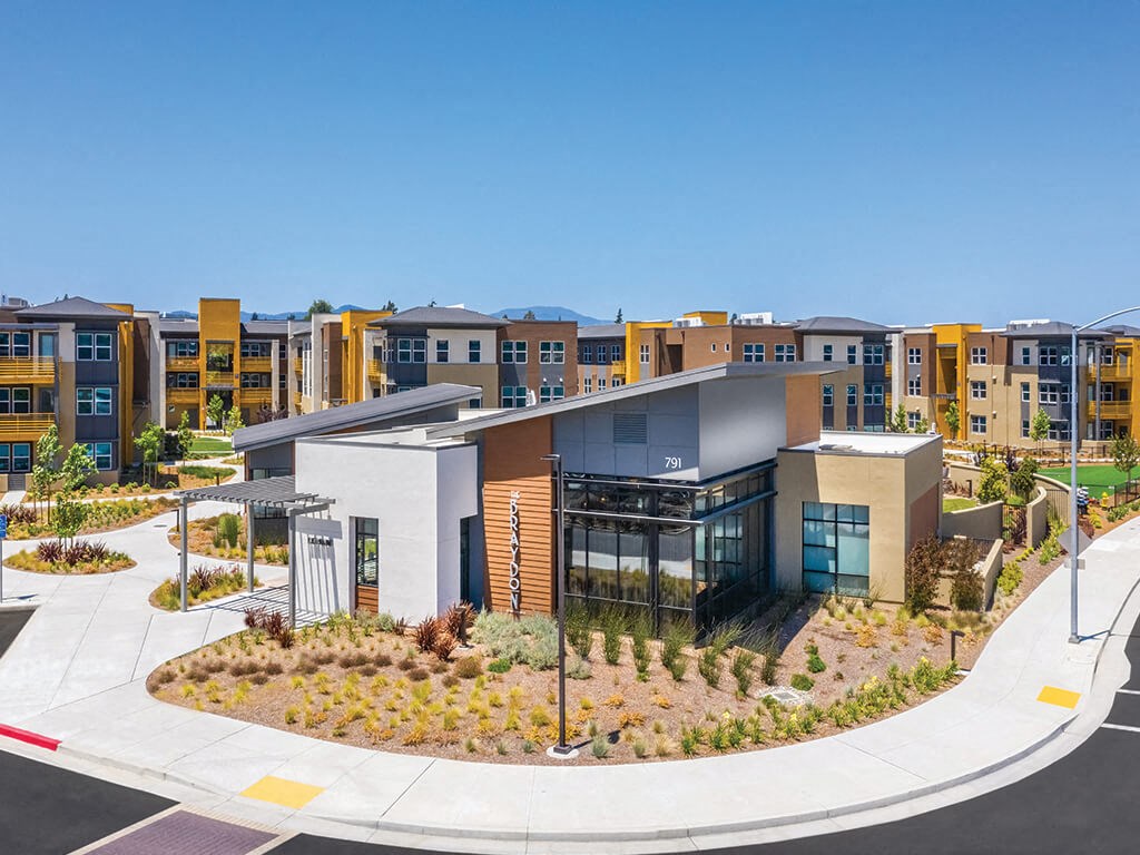 an aerial view of a building with a garden in front of it