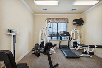 Fitness room with machines at Parkway Senior Apartments in Pasadena TX - Photo Gallery 8