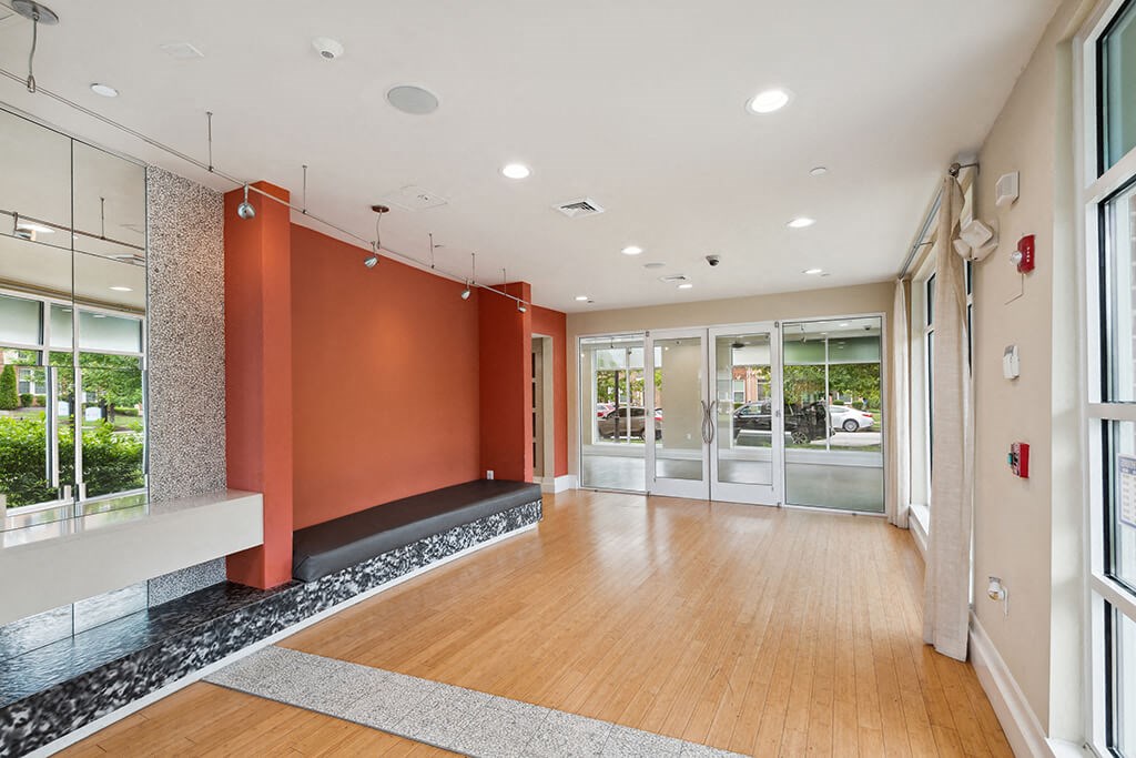 the lobby of a building with doors and a wood floor