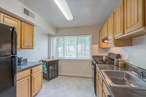 a kitchen with wooden cabinets and stainless steel appliances