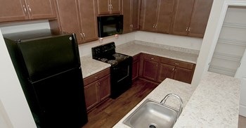 Kitchen with black appliances at Riverwoods, Riverwoods at Towne Square, and Riverwoods at Lake Ridge in Woodbridge VA