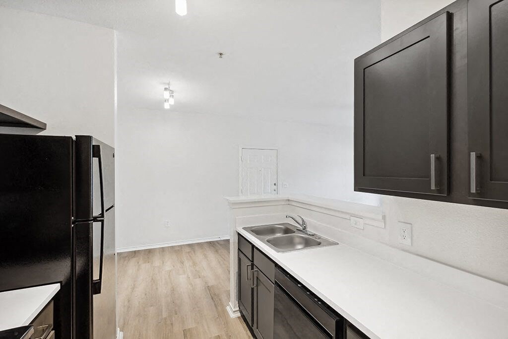 Kitchen with black appliances at Bonito Parque Apartments in San Antonio TX